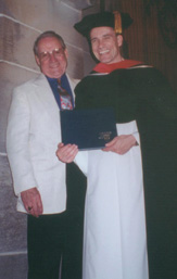 Father Andrew Carl with his father after receiving his doctorate degree.