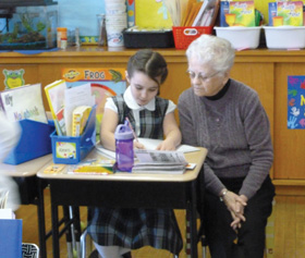 A Sister of St. Joseph works with a second-grade student at Nazareth Hall. Nazareth has around 14 active sisters at any one time in the school.