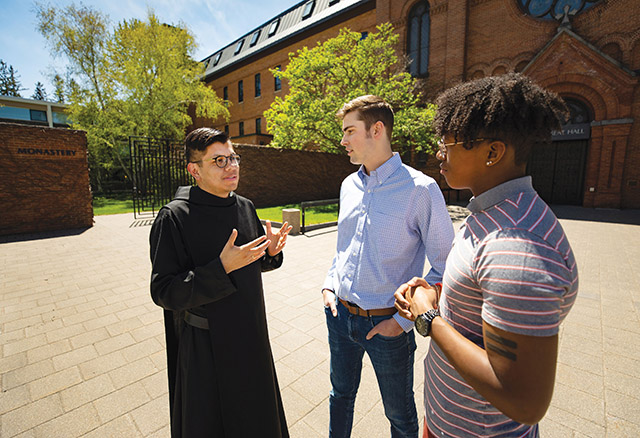 Brother Mariano Mendez, O.S.B. answers questions from students at St. John’s University.
