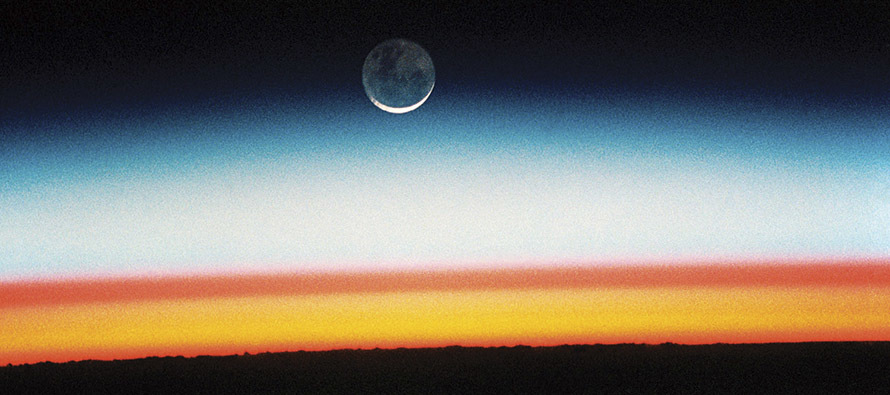 This photo, taken from the Space Shuttle Columbia in 1992, shows a moonrise and sunrise from outer space. 